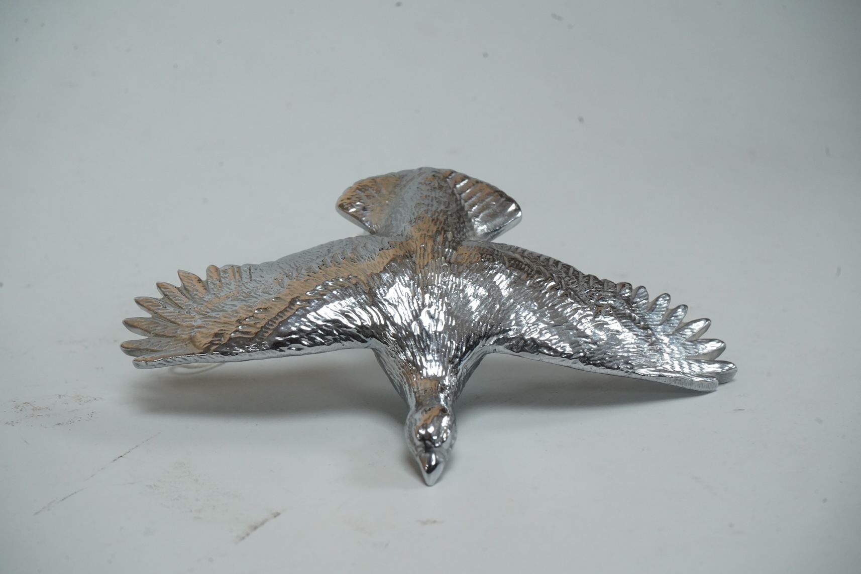 A Louis Lejeune cast chrome plated car mascot modelled as a bird in flight, wing span 12cm